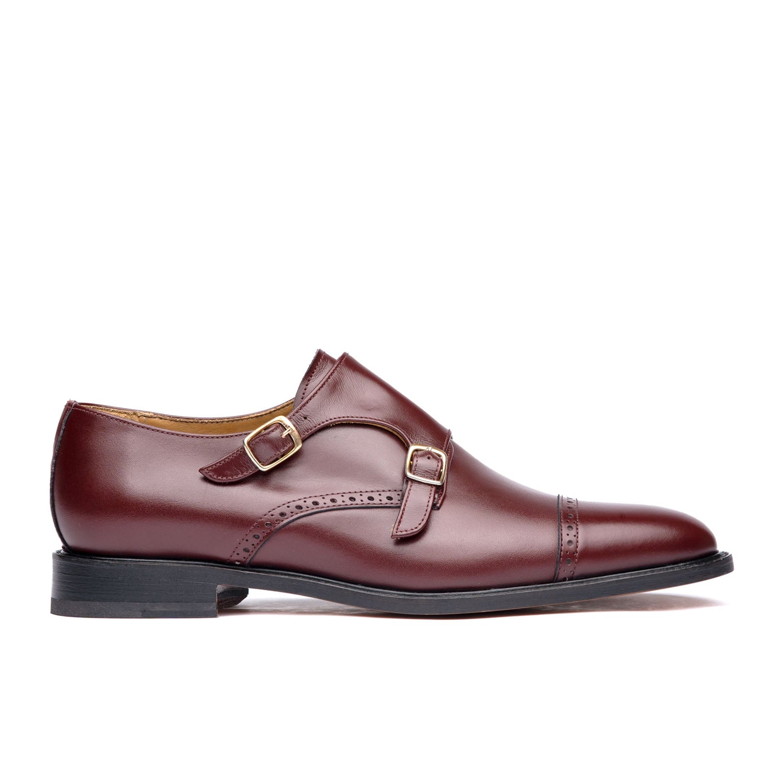 Burgundy monk strap shoes with offset buckles and leather sole