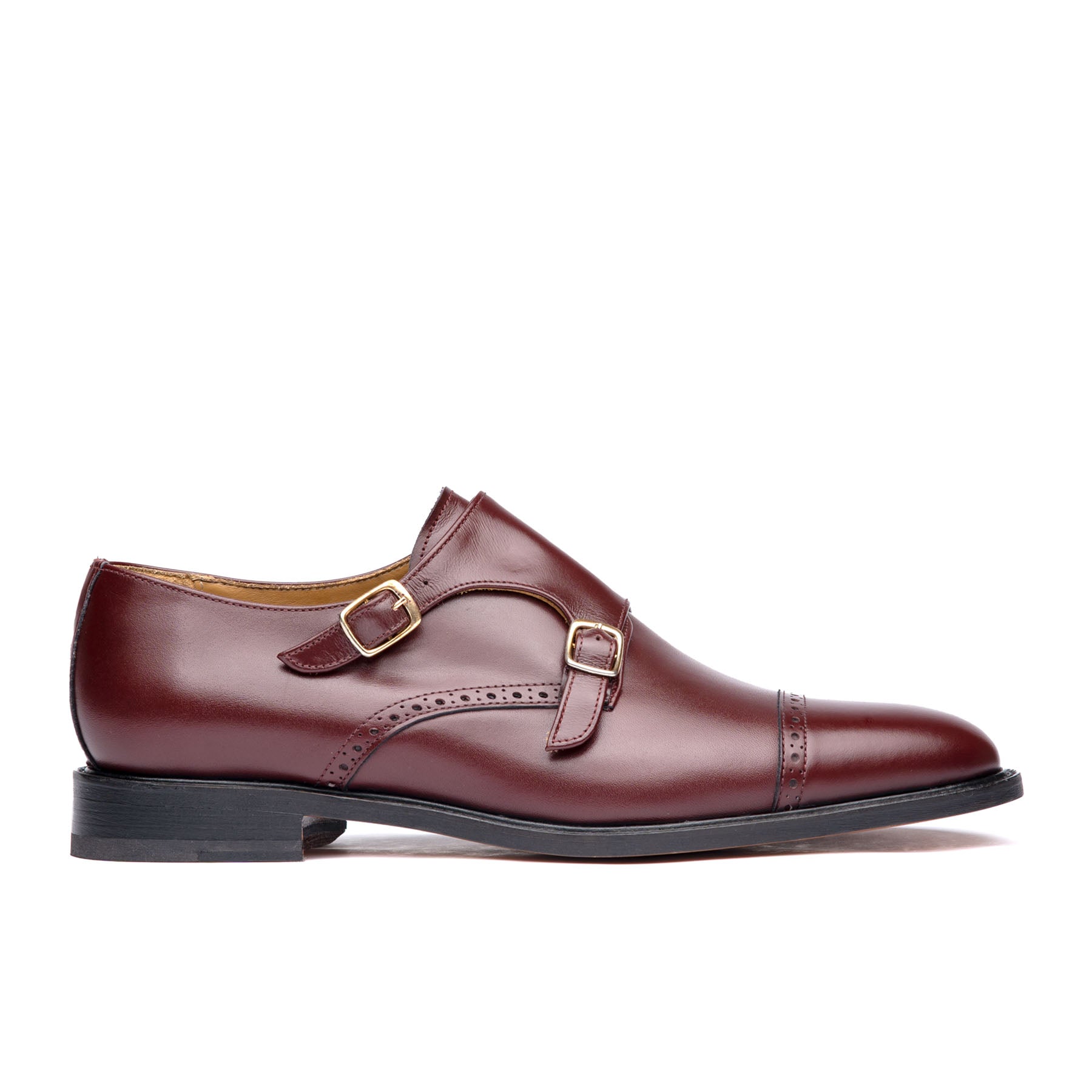 Burgundy monk strap shoes with offset buckles and leather sole