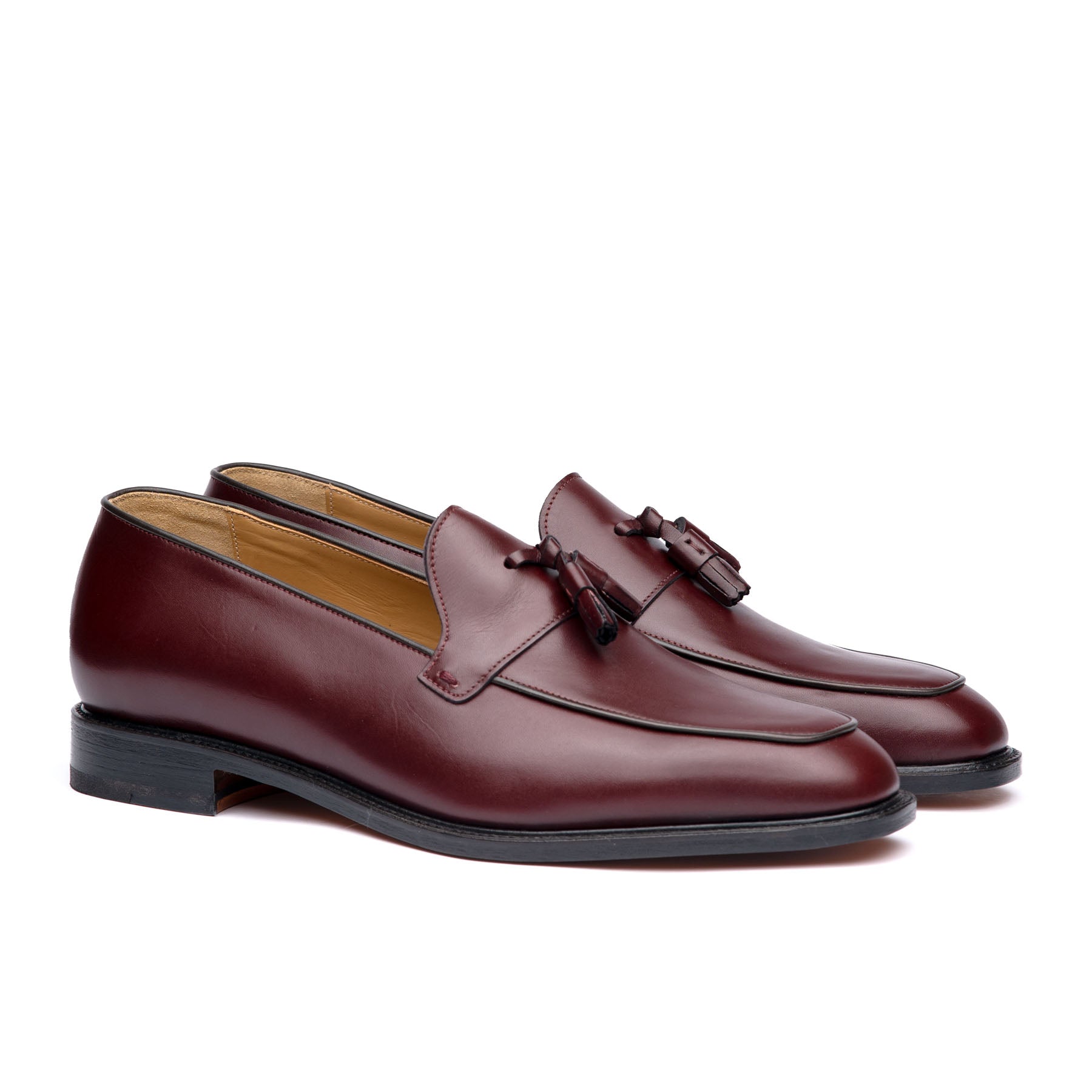 Burgundy tassel loafers crafted using, aniline dyed calf leather with suede finish at the heel cap 