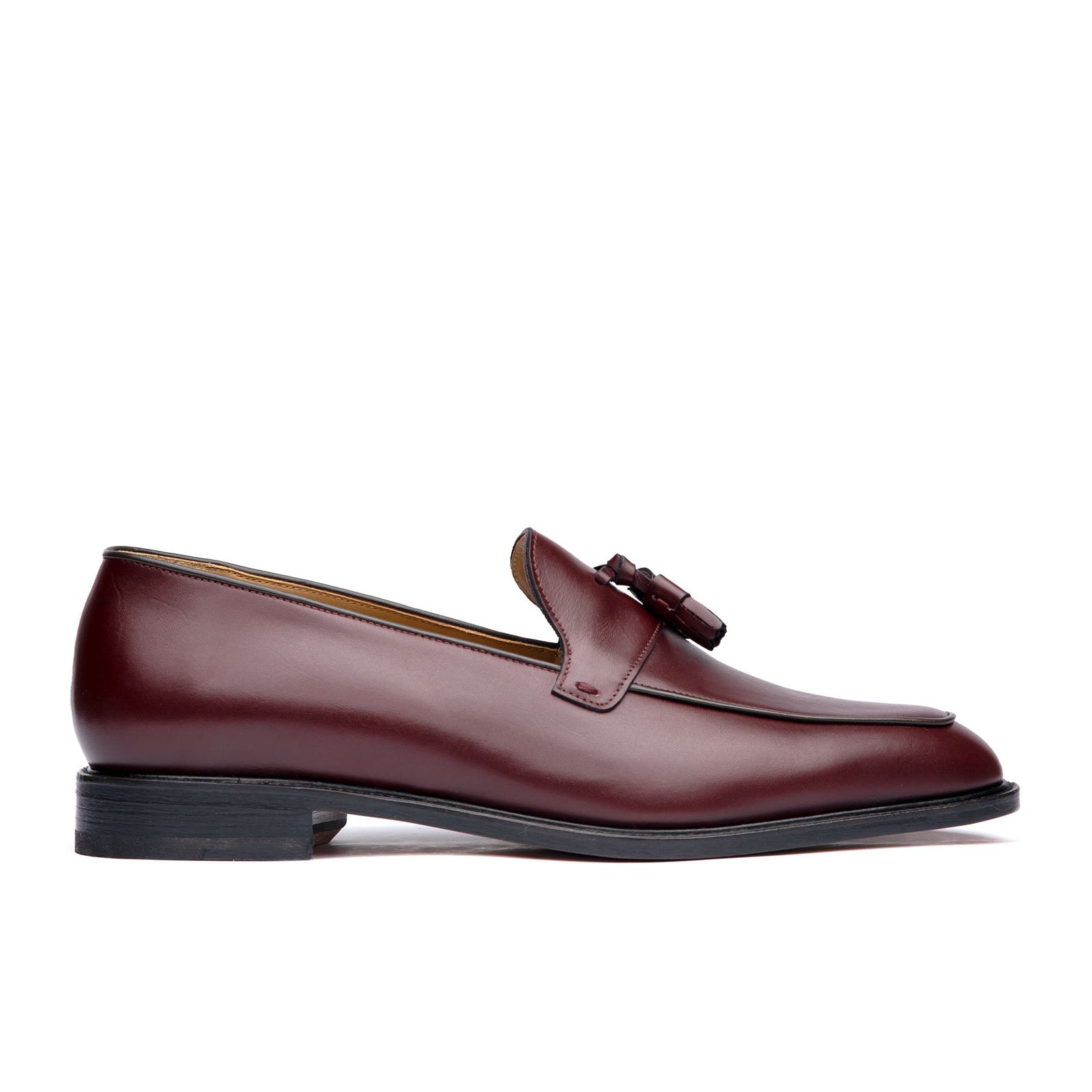 Burgundy tassel loafers crafted using, aniline dyed calf leather with suede finish at the heel cap 