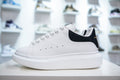 ** Alexander McQueen White Sneakers with Black Suede Detail

**