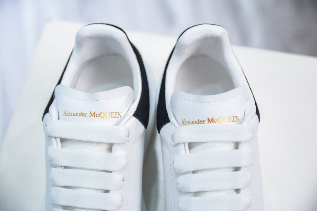 ** Alexander McQueen White Sneakers with Black Suede Detail

**