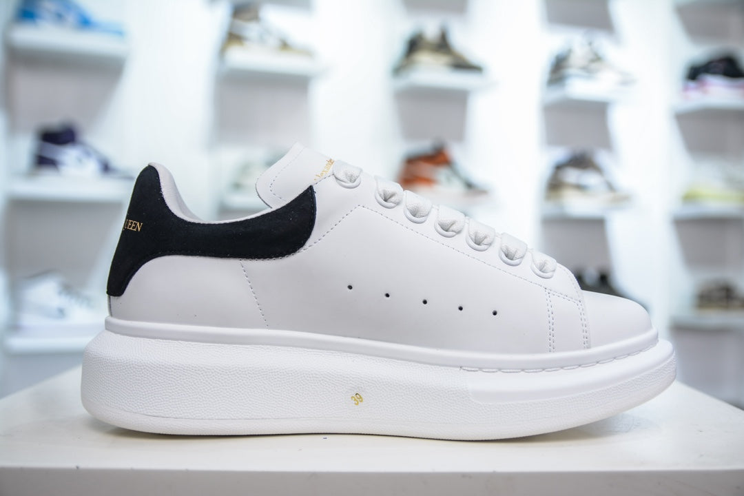 ** Alexander McQueen White Sneakers with Black Suede Detail

**
