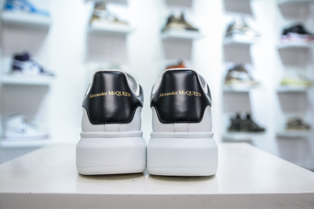 ** Alexander McQueen White Sneakers with Black Suede Detail

**