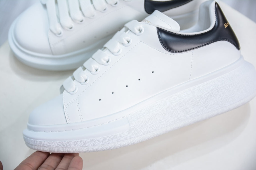 ** Alexander McQueen White Sneakers with Black Suede Detail

**