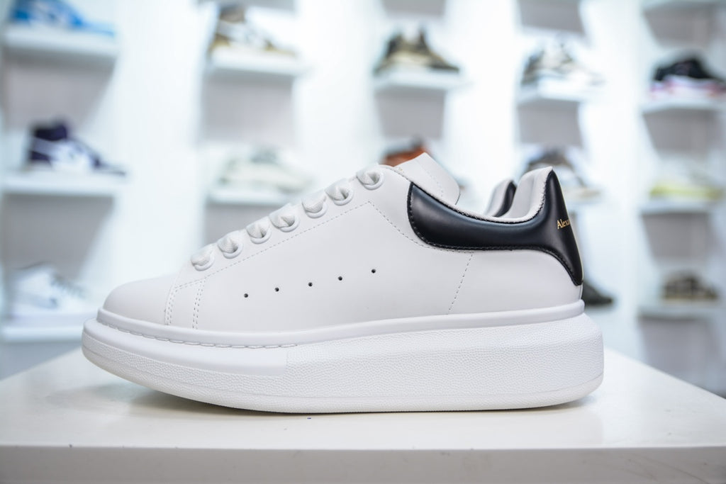 ** Alexander McQueen White Sneakers with Black Suede Detail

**