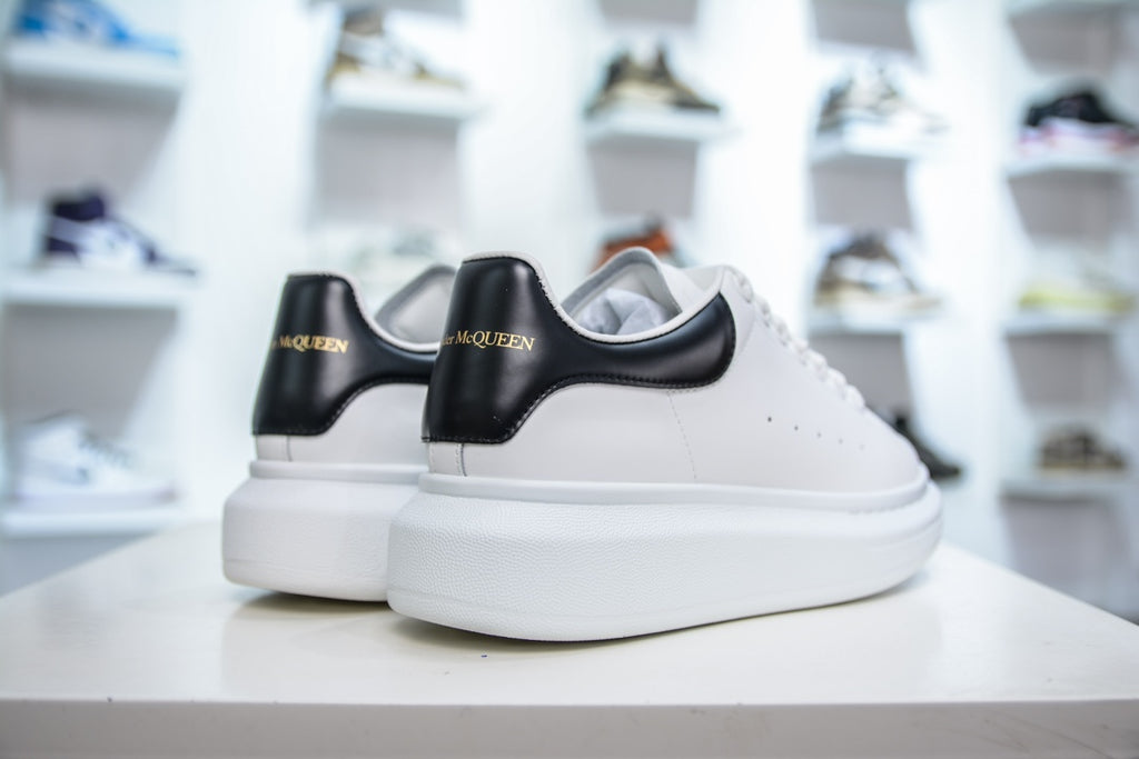 ** Alexander McQueen White Sneakers with Black Suede Detail

**