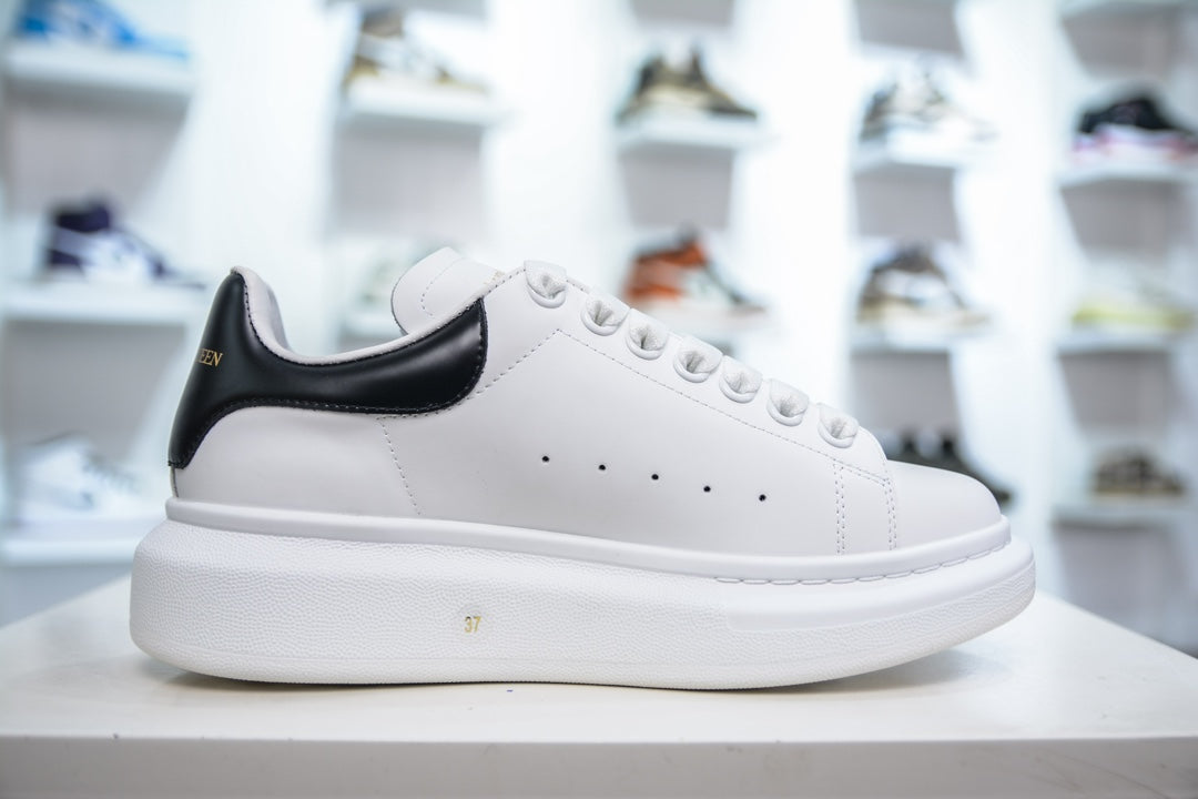** Alexander McQueen White Sneakers with Black Suede Detail

**