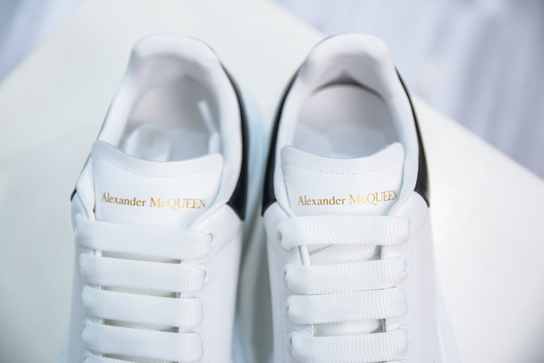 ** Alexander McQueen White Sneakers with Black Suede Detail

**